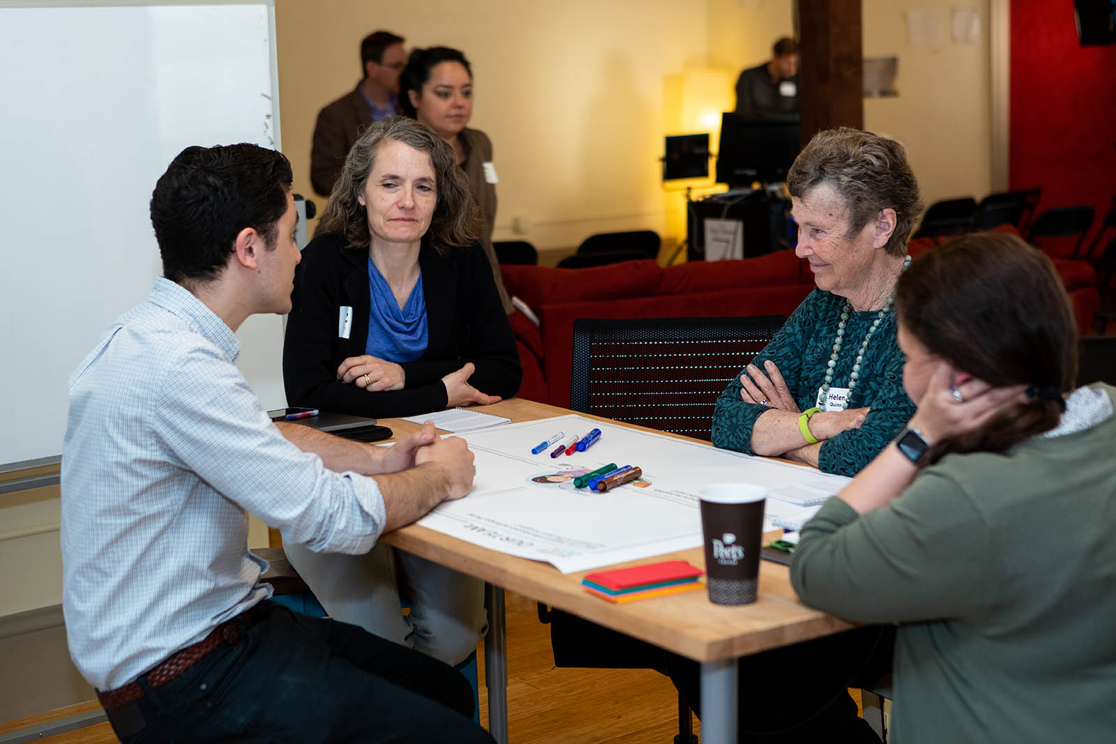 Collaborating across disciplines. Concord Consortium developer Eli Kosminsky and Director of Impact Jen Goree brainstorm with learning researcher and assessment specialist Britte Cheng and Helen Quinn, Professor Emerita of Particle Physics and Astrophysics.